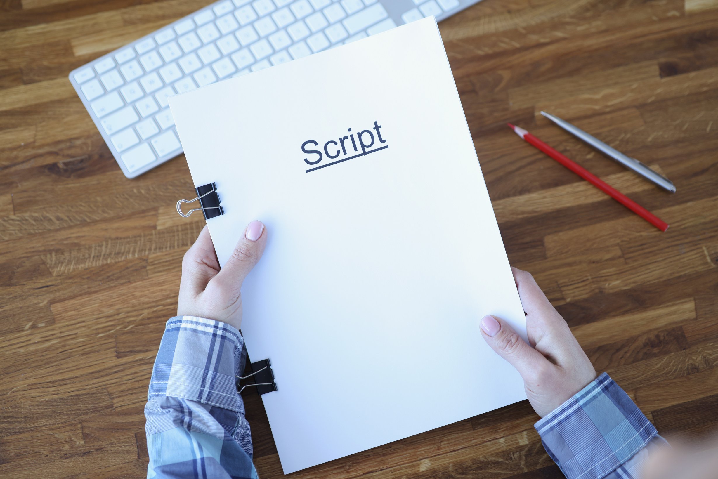 Screenwriter Holds Folder Of Documents Labeled Script